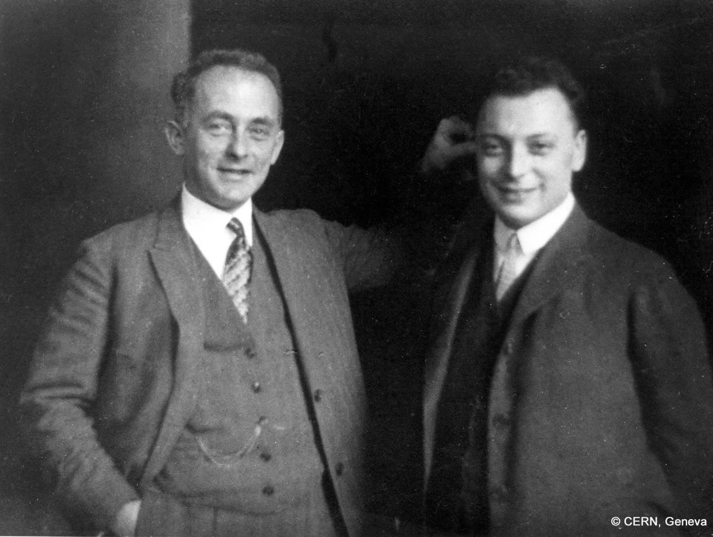 Wolfgang Pauli stands to the right of Max Born, who holds him by the ear