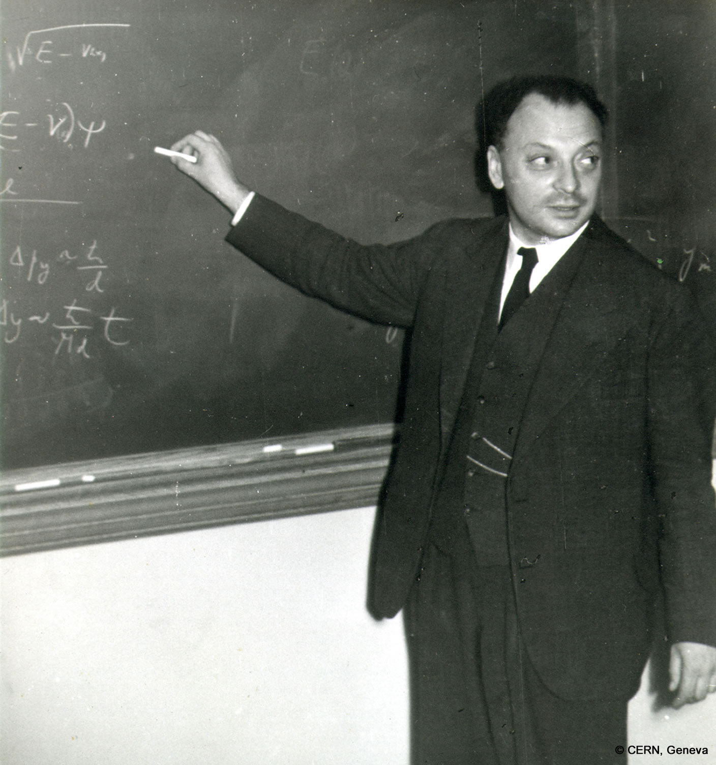 Wolfgang Pauli writes on a blackboard